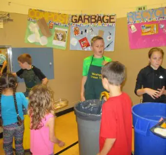 Children with waste bins